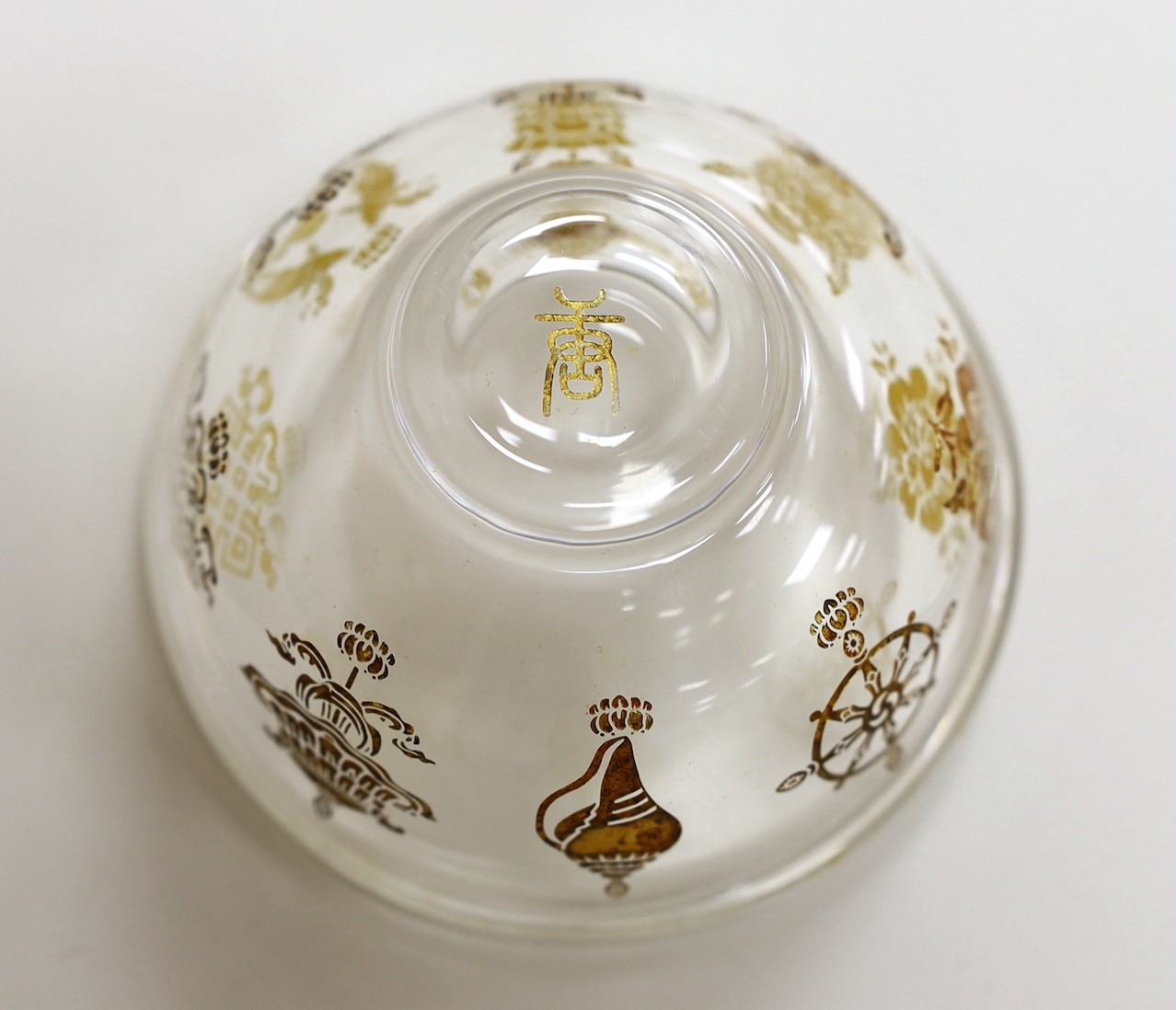 A Tibetan glass gilt decorated 'eight Buddhist emblems' bowl, 9cms diameter